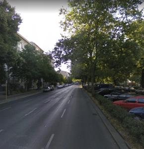 an empty street with cars parked on the side of the road at Beautiful 3 Room apartment in Kreuzberg in Berlin