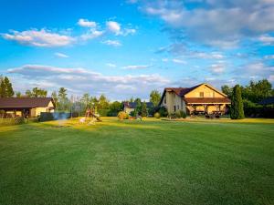 a large yard with a house and a playground at Prosportówek - Powidz - Dom Bliźniak nad Jeziorem z Dużym Ogrodem in Powidz +94 photos