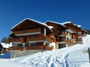 a building with snow on the ground in front of it at Appartement Peisey-Vallandry, 3 pièces, 6 personnes - FR-1-411-648 in Landry