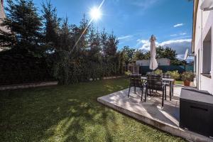 a patio with a table and an umbrella at XLSuite Apartment Comfort in Piešťany