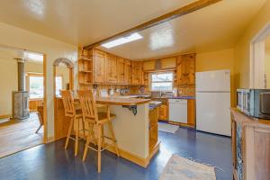 a kitchen with wooden cabinets and a table and chairs at El Nido The Nest in Arcata