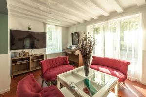 Quincy-Voisins的住宿－La Creste Disneyland Bmyguest，客厅配有红色椅子和玻璃桌