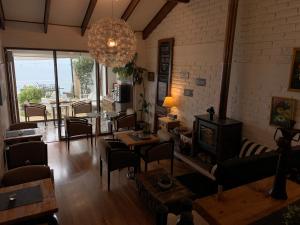 a living room filled with furniture and a chandelier at Laura del Mar Hotel Boutique in Concón