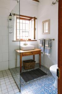 a bathroom with a sink and a glass shower at Beaumont Family Wines in Botrivier