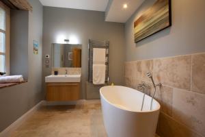 Kúpeľňa v ubytovaní Roques Cottage - Spacieuse maison pierre avec piscine chauffée, cuisine d'été, pétanque, ping-pong et jeux enfants - 10 min de Vic