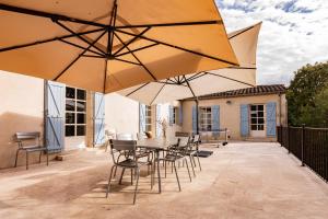 Patio alebo iná vonkajšia časť ubytovania Roques Cottage - Spacieuse maison pierre avec piscine chauffée, cuisine d'été, pétanque, ping-pong et jeux enfants - 10 min de Vic