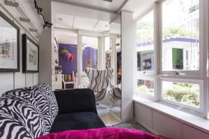 a living room with a couch and a window at Morada das Flôres in Porto Alegre