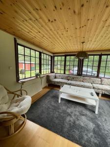 a living room with a couch and a table at Ljunghusen Holiday Inn Cottage in Ljunghusen