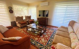 a living room with two couches and a coffee table at Quinta Da Porta Caseira in Resende