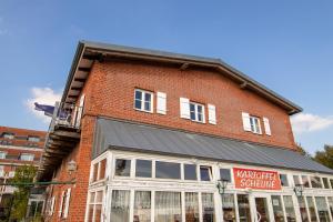 a red brick building with a watchdog software sign on it at Modernes Appartement am See in Waren