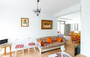 a living room with a couch and a table and chairs at Pet Friendly Apartment In Playa Honda With Kitchen in Playa Honda