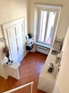 una piccola cucina con una grande finestra e un tavolo di Vicolo Doria Apartment a Roma