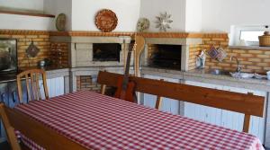 a kitchen with a table and a fireplace at Quinta Da Porta Caseira in Resende +32 photos