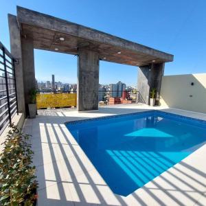 a swimming pool on the roof of a house at Aires del Sur in San Miguel de Tucumán