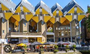 um grande edifício com telhados amarelos e cinzentos em B&B Het Smitshoekje em Barendrecht