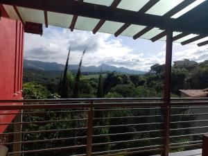 a view of the mountains from a balcony at Pousada Verde Villas in Brumadinho