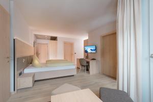 Postel nebo postele na pokoji v ubytování Familotel Alphotel