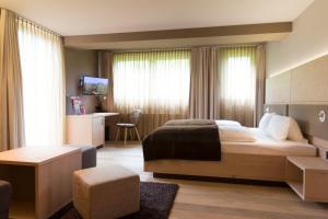 Postel nebo postele na pokoji v ubytování Familotel Alphotel