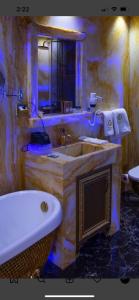 ein Badezimmer mit einem Waschbecken, einer Badewanne und einem WC in der Unterkunft Hotel Mamounia Boutique in Pristina