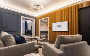 a living room with two chairs and a yellow wall at One Luxury Suites in Belgrade