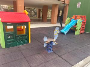 a playground with two play equipment in a building at Airport Madrid suites apartments Belfast 13 in Madrid