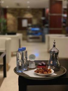 a tray with a plate of food on a table at فندق البروج in Jazan