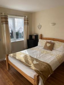 a large bed in a bedroom with a window at Clarendon Lodge - accommodation only in Skegness