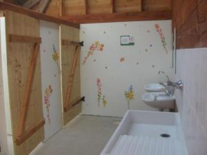 a bathroom with a sink and a toilet at La ferme de Piardiere in Plessé