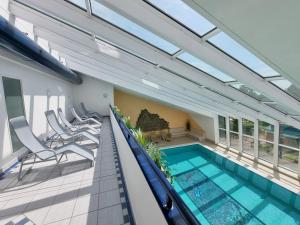 an indoor swimming pool in a house with at Meerblick 424 im Haus Trafalgar in Cuxhaven