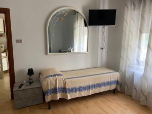 Zimmer mit einem kleinen Tisch und einem Spiegel in der Unterkunft Residenza Kob in Arco