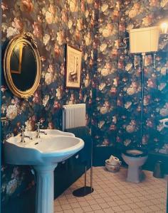 a bathroom with a sink and a toilet at Mollys Boutique Hotel in Ilkley +22 photos