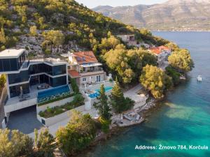 an aerial view of a house on the water at Tara's Lodge Hotel in Korčula