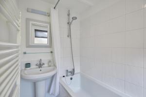 a white bathroom with a sink and a bath tub at Host & Stay - Waterlily Cottage in Great Ayton
