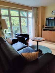 a living room with a couch and a table at Fewo B 34 Am Weststrand Toplage in Kühlungsborn
