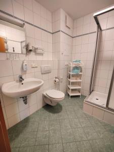 a bathroom with a toilet and a sink at Fewo B 34 Am Weststrand Toplage in Kühlungsborn
