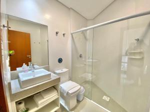 a bathroom with a toilet and a sink and a shower at Dona Floripa in Florianópolis