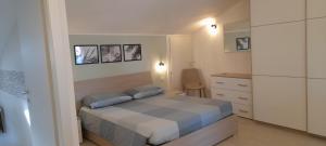 Postel nebo postele na pokoji v ubytování Appartamento LA ROTONDA
