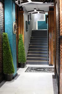 a hallway with stairs and plants in front of a building at E-lite& Meatador in Astana