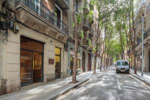 una furgoneta estacionada en una calle al lado de los edificios en AG Apartments, en Barcelona