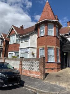 a house with a car parked in front of it at Knighton Lodge in Skegness