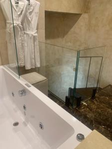 a bathroom with a bath tub with a glass shower at Donati Luxury Tower Suites in Florence