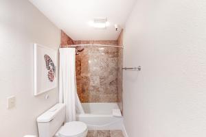 a white bathroom with a toilet and a shower at Ketchum Getaways in Ketchum