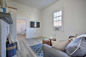 a living room with a couch and a fireplace at Modern New Orleans Condo Near LSU and Downtown! in New Orleans