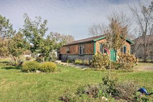 an old brick house in a yard at Quaint Ironton Getaway with Fire Pit, Gas Grill! in Ironton