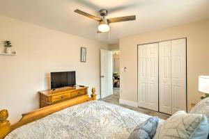 a bedroom with a bed and a flat screen tv at Turquoise Escape about 1 Mi to Sailfish Marina! in West Palm Beach