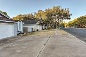 an empty street in a neighborhood with houses at Gorgeous Austin Getaway about 8 Mi to Downtown! in Austin