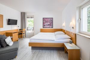 Un pat sau paturi într-o cameră la Hotel Görtler