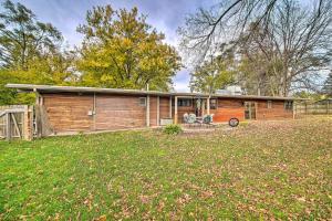 a wooden house with a fence and a yard at Chic Fox River Grove Home with Great Location! in Fox River Grove