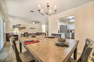 a dining room and living room with a table and chairs at Charming Tallahassee Home 1 Mi to Lake Ella! in Tallahassee