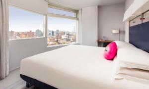 a hotel room with a bed and a window at The Standard - East Village in New York